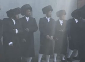 Rapper Nissim Black filming his new hit song accompanied by actors who are all wearing shtreimels and white socks.#onlysimchas